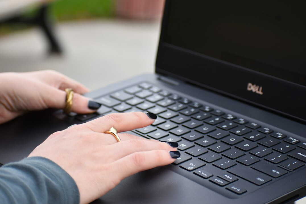 writer typing on laptop